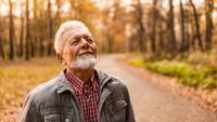 Older man enjoying walk through trails